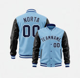 Light blue varsity jacket with black leather sleeves on a white background
