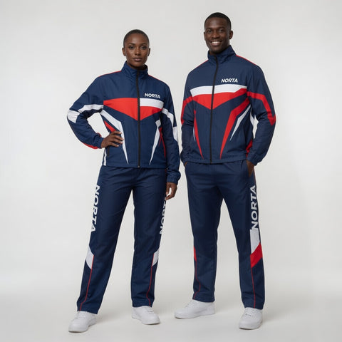 Two people wearing matching blue tracksuits with red and white accents on a white background