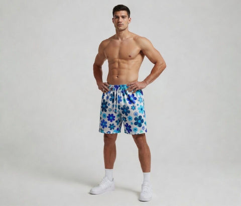 Man wearing blue floral swim shorts on a white background
