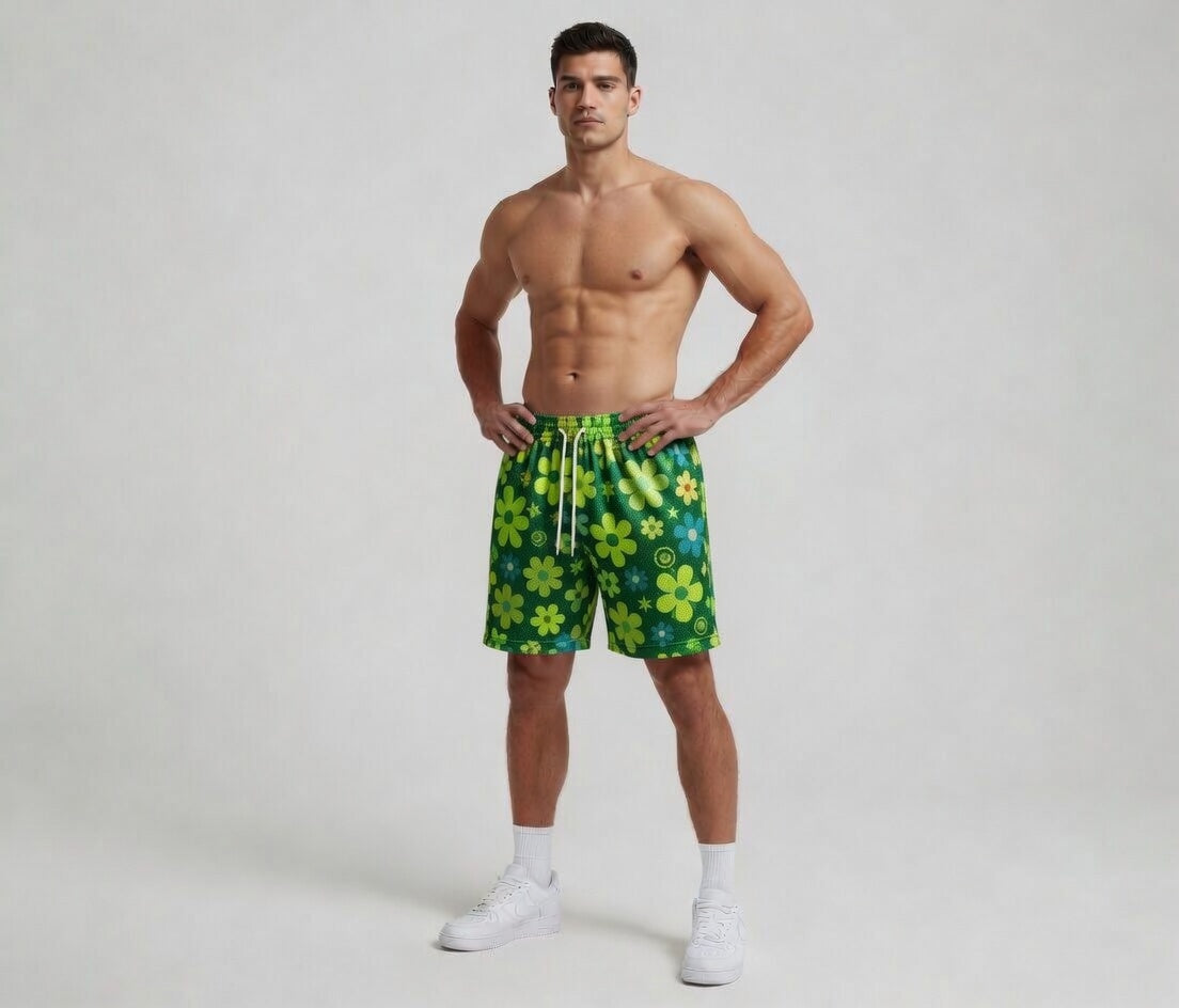 Man wearing green floral swim shorts on a white background