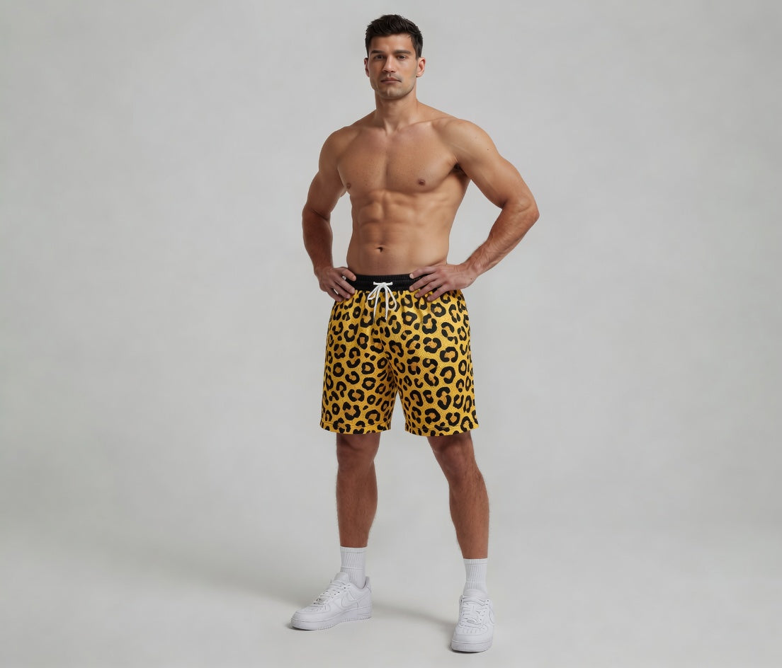 Man wearing yellow leopard print shorts on a gray background