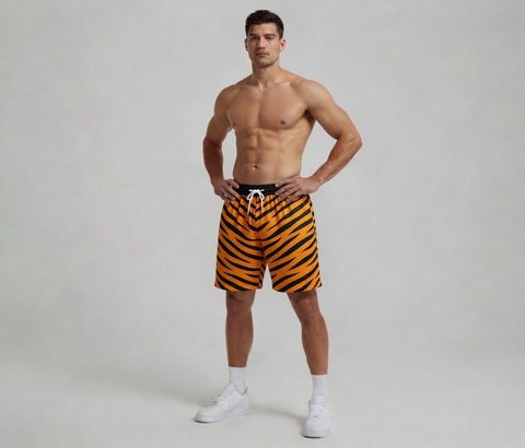 Man wearing tiger-striped swim shorts on a plain background