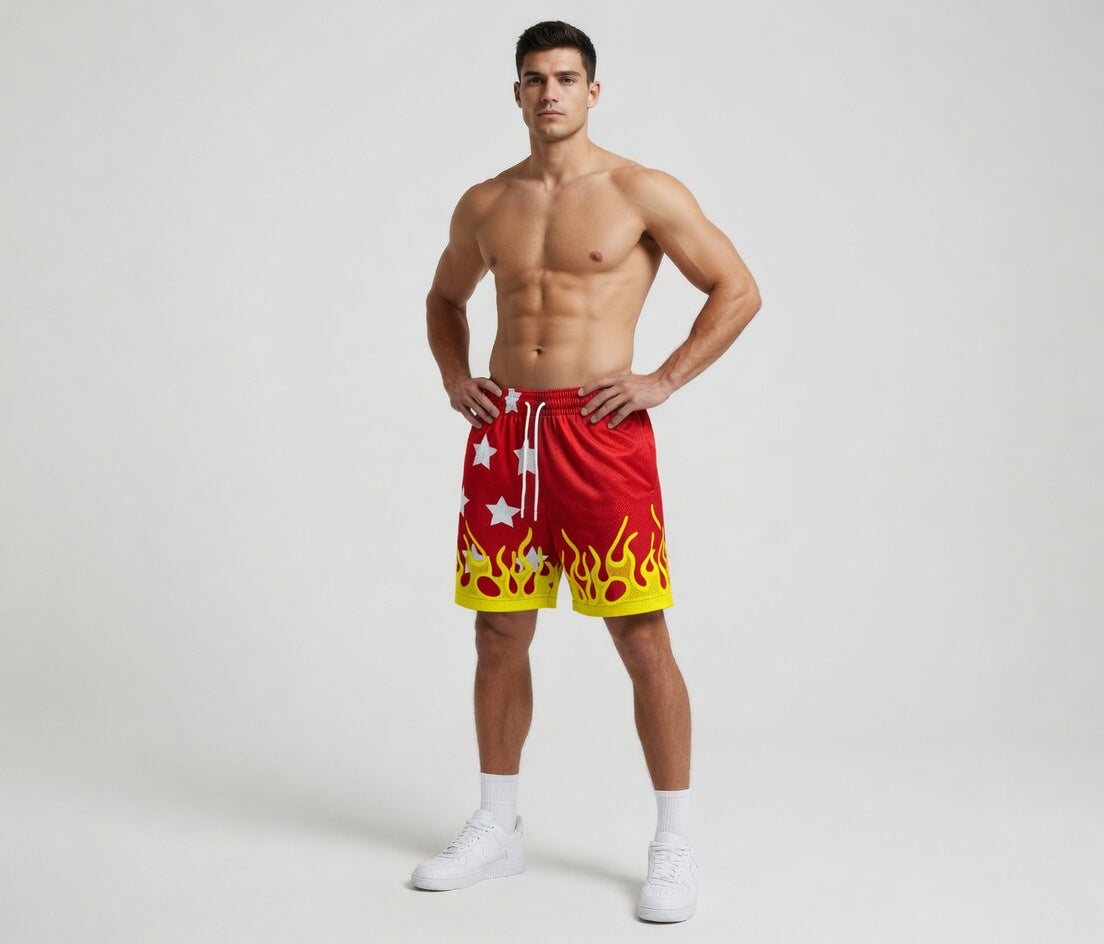 Man wearing red and yellow shorts with flame design on a white background