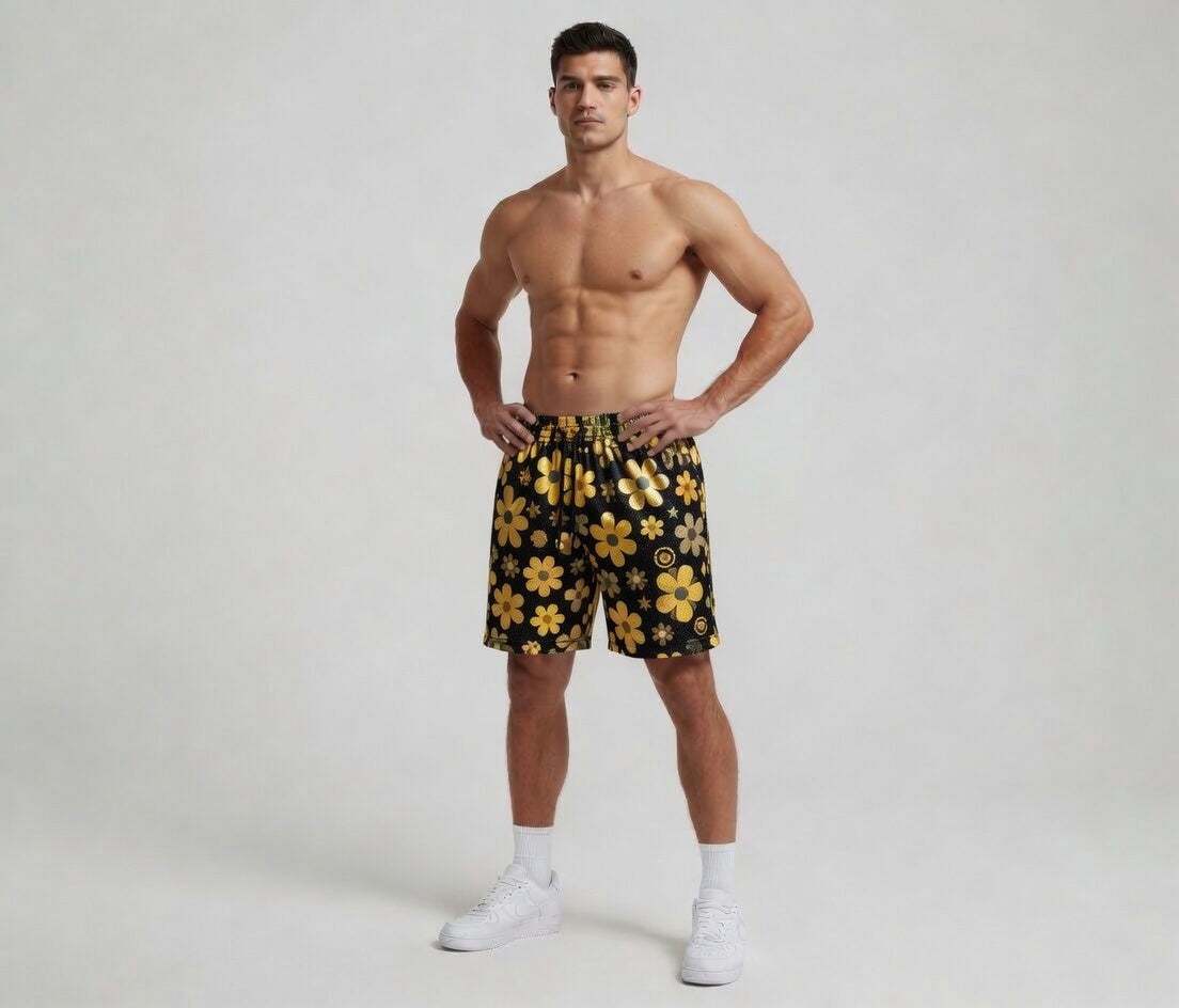 Man wearing black shorts with yellow floral patterns on a white background