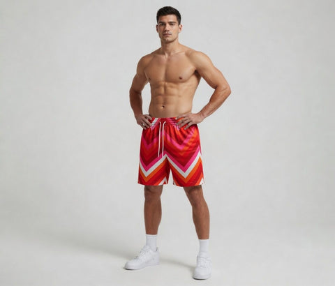 Man wearing colorful swim shorts on a plain background