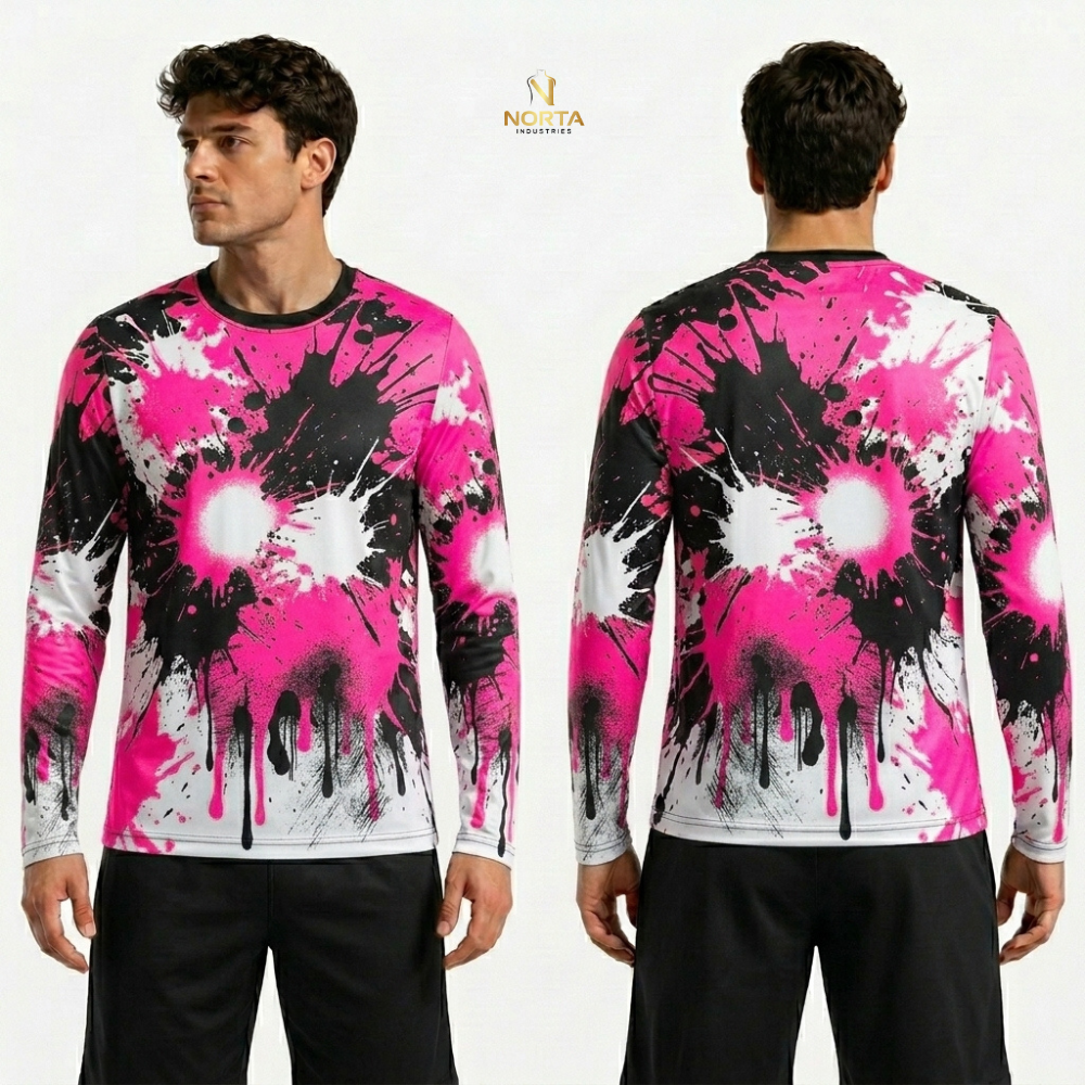 Long-sleeve shirt with pink, black, and white splatter design worn by a model on a white background.